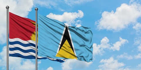 Kiribati and Saint Lucia flag waving in the wind against white cloudy blue sky together. Diplomacy...