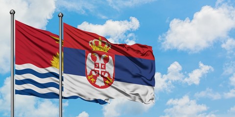 Kiribati and Serbia flag waving in the wind against white cloudy blue sky together. Diplomacy concept, international relations.