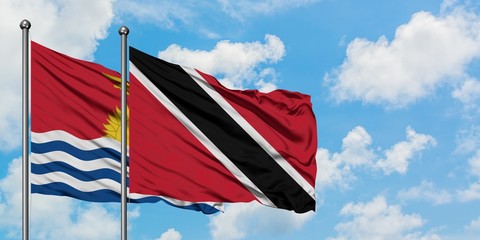 Kiribati and Trinidad And Tobago flag waving in the wind against white cloudy blue sky together. Diplomacy concept, international relations.