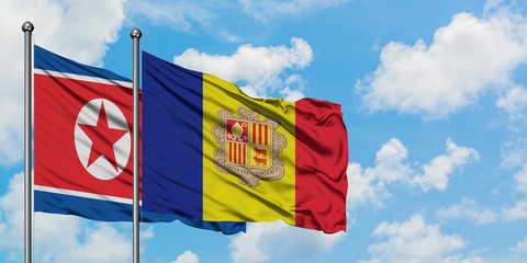 North Korea and Andorra flag waving in the wind against white cloudy blue sky together. Diplomacy concept, international relations.