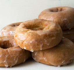 Fototapeta na wymiar Close up of six plain glazed cake doughnuts. 