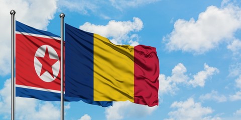 North Korea and Chad flag waving in the wind against white cloudy blue sky together. Diplomacy concept, international relations.