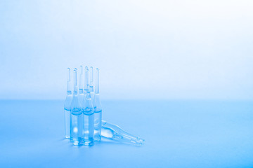 Fototapeta na wymiar transparent medical ampoules on a blue background