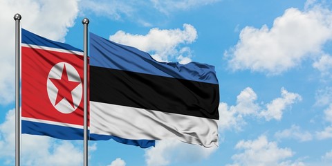 North Korea and Estonia flag waving in the wind against white cloudy blue sky together. Diplomacy concept, international relations.