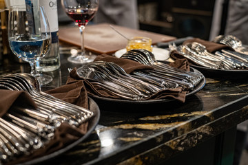 forks and knives, vine glasses on a kitchen
