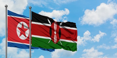 North Korea and Kenya flag waving in the wind against white cloudy blue sky together. Diplomacy...