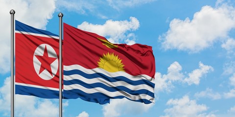 North Korea and Kiribati flag waving in the wind against white cloudy blue sky together. Diplomacy concept, international relations.