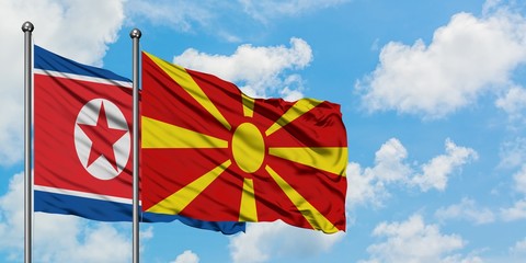 North Korea and Macedonia flag waving in the wind against white cloudy blue sky together. Diplomacy concept, international relations.