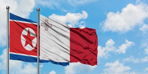 North Korea and Malta flag waving in the wind against white cloudy blue sky together. Diplomacy concept, international relations.