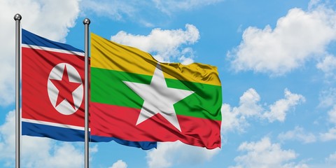 North Korea and Myanmar flag waving in the wind against white cloudy blue sky together. Diplomacy concept, international relations.