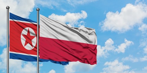 North Korea and Poland flag waving in the wind against white cloudy blue sky together. Diplomacy concept, international relations.
