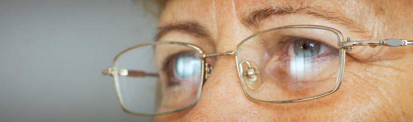 senior woman with specs eyes macro shot 