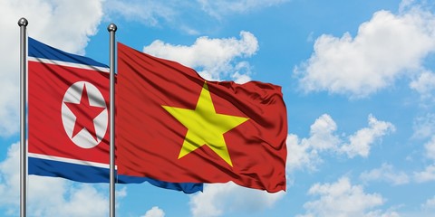 North Korea and Vietnam flag waving in the wind against white cloudy blue sky together. Diplomacy concept, international relations.