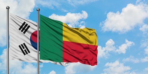 South Korea and Benin flag waving in the wind against white cloudy blue sky together. Diplomacy concept, international relations.