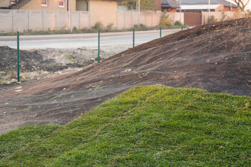 Installing grass turf rolls for new garden lawn