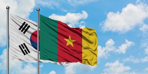 South Korea and Cameroon flag waving in the wind against white cloudy blue sky together. Diplomacy concept, international relations.
