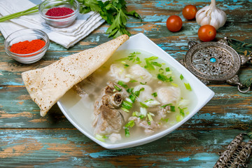 lamb noodle soup on wooden table