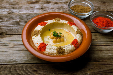 Traditional homemade hummus on wooden table