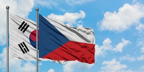 South Korea and Czech Republic flag waving in the wind against white cloudy blue sky together. Diplomacy concept, international relations.