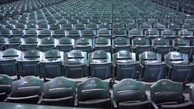 Indoor Stadium Seating With Hundreds Of Empty Green Fold Up Seats.