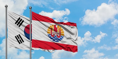 South Korea and French Polynesia flag waving in the wind against white cloudy blue sky together. Diplomacy concept, international relations.