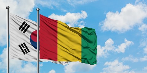 South Korea and Guinea flag waving in the wind against white cloudy blue sky together. Diplomacy concept, international relations.