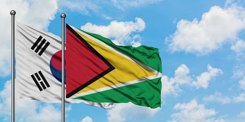 South Korea and Guyana flag waving in the wind against white cloudy blue sky together. Diplomacy concept, international relations.