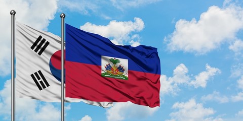 South Korea and Haiti flag waving in the wind against white cloudy blue sky together. Diplomacy concept, international relations.