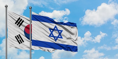 South Korea and Israel flag waving in the wind against white cloudy blue sky together. Diplomacy concept, international relations.