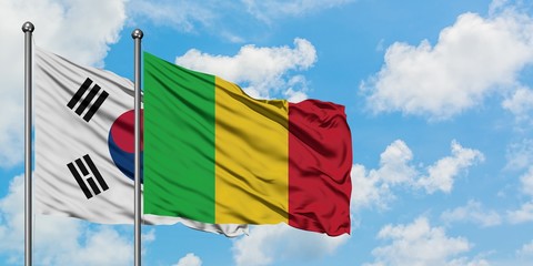 South Korea and Mali flag waving in the wind against white cloudy blue sky together. Diplomacy concept, international relations.