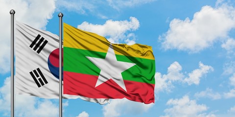 South Korea and Myanmar flag waving in the wind against white cloudy blue sky together. Diplomacy concept, international relations.