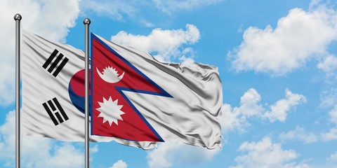 South Korea and Nepal flag waving in the wind against white cloudy blue sky together. Diplomacy concept, international relations.