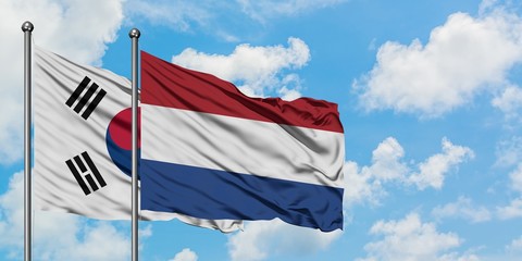 South Korea and Netherlands flag waving in the wind against white cloudy blue sky together. Diplomacy concept, international relations.