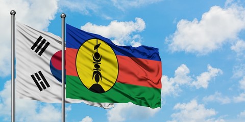 South Korea and New Caledonia flag waving in the wind against white cloudy blue sky together. Diplomacy concept, international relations.