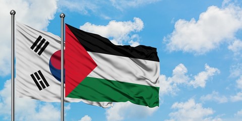South Korea and Palestine flag waving in the wind against white cloudy blue sky together. Diplomacy concept, international relations.