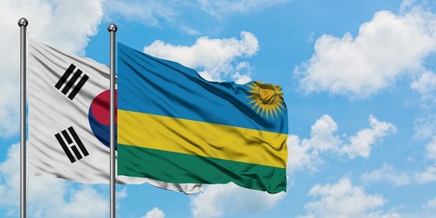 South Korea and Rwanda flag waving in the wind against white cloudy blue sky together. Diplomacy concept, international relations.