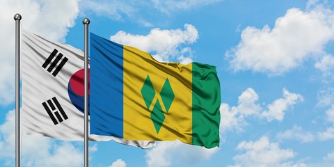 South Korea and Saint Vincent And The Grenadines flag waving in the wind against white cloudy blue sky together. Diplomacy concept, international relations.