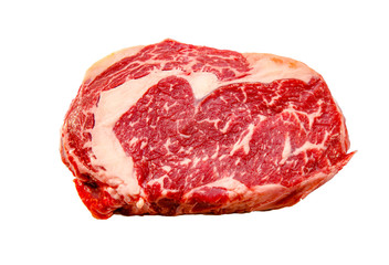 A rib eye steak of marbled grain-fed beef lies on a white background. Isolated.