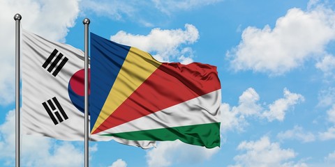 South Korea and Seychelles flag waving in the wind against white cloudy blue sky together. Diplomacy concept, international relations.