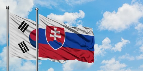 South Korea and Slovakia flag waving in the wind against white cloudy blue sky together. Diplomacy concept, international relations.