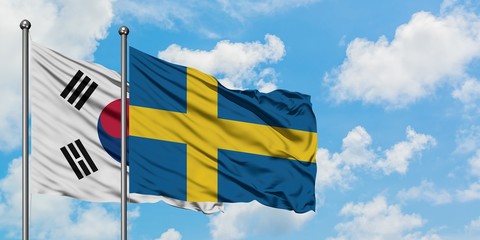 South Korea and Sweden flag waving in the wind against white cloudy blue sky together. Diplomacy concept, international relations.