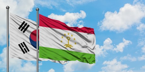 South Korea and Tajikistan flag waving in the wind against white cloudy blue sky together. Diplomacy concept, international relations.
