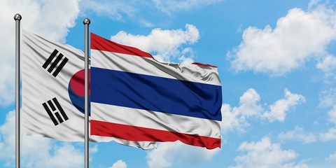South Korea and Thailand flag waving in the wind against white cloudy blue sky together. Diplomacy concept, international relations.