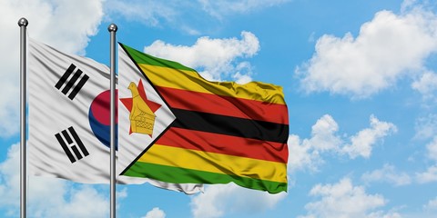 South Korea and Zimbabwe flag waving in the wind against white cloudy blue sky together. Diplomacy concept, international relations.
