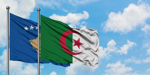 Kosovo and Algeria flag waving in the wind against white cloudy blue sky together. Diplomacy concept, international relations.