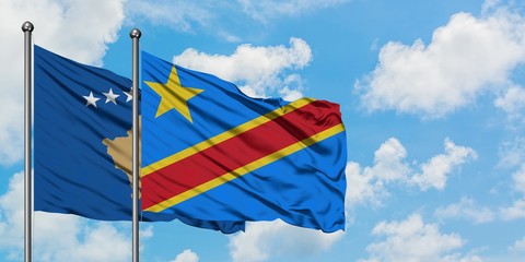 Kosovo and Congo flag waving in the wind against white cloudy blue sky together. Diplomacy concept, international relations.