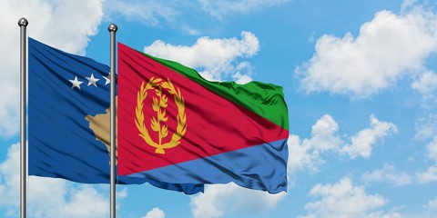 Kosovo and Eritrea flag waving in the wind against white cloudy blue sky together. Diplomacy concept, international relations.