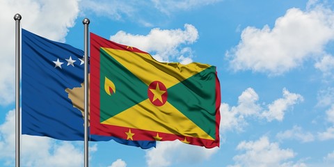 Kosovo and Grenada flag waving in the wind against white cloudy blue sky together. Diplomacy concept, international relations.