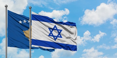 Kosovo and Israel flag waving in the wind against white cloudy blue sky together. Diplomacy concept, international relations.