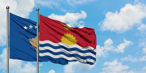 Kosovo and Kiribati flag waving in the wind against white cloudy blue sky together. Diplomacy concept, international relations.